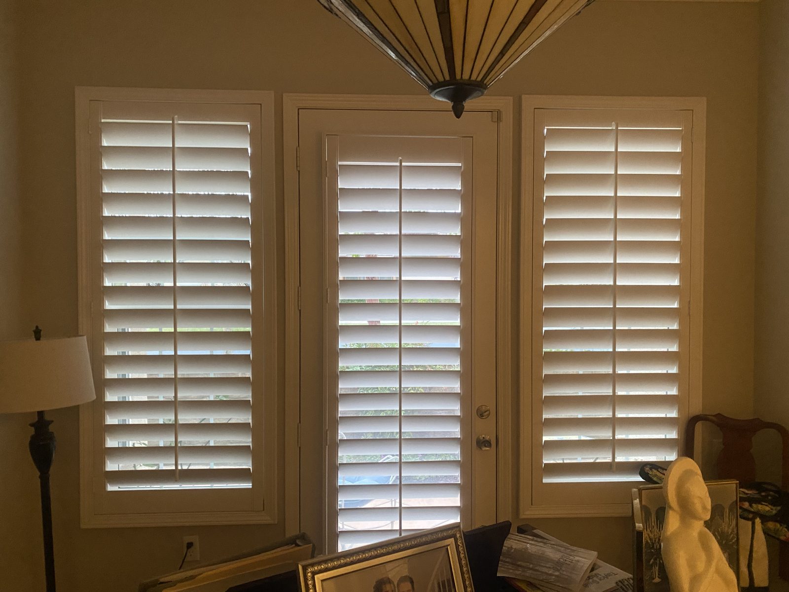 Two light roller shades lowered over French doors